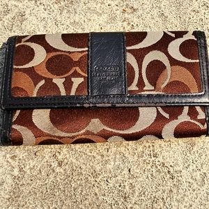 Vintage Coach brown and tan monogrammed trifold wallet, some wear in leather